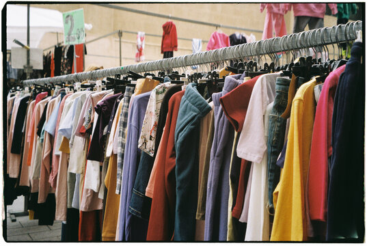 second-hand clothes at outdoor market stall, 35mm