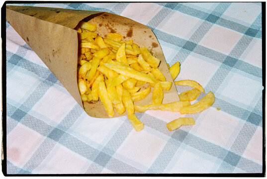 spilled fries on plaid tablecloth, 35mm
