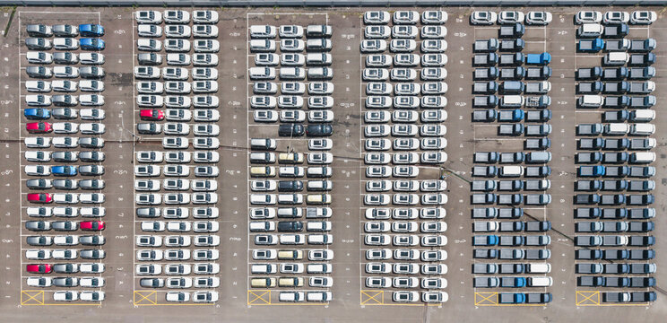 Aerial view of new cars at a dealership parking lot