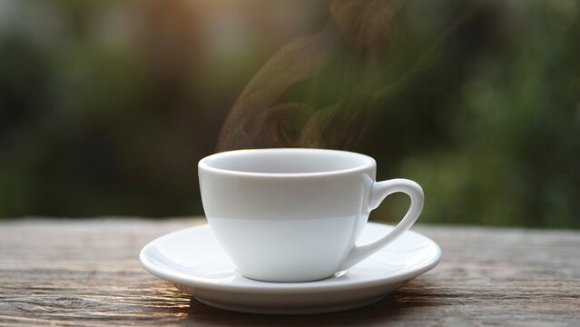 Hot Coffee Cup. Hot coffee white cup on old wood table with steam rising, symbolizing warmth, energy, and relaxation. Perfect for cafe, breakfast, beverage, or morning lifestyle. Coffee Concept.