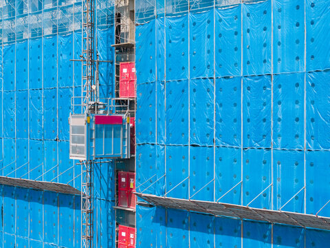 Construction site temporary elevator building progress