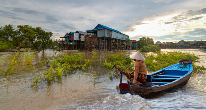 Tonle Sap lake, Siem reap Province, Cambodia. Fisherman in his boat, Floating village of Kompong Phluk, Cambodia.