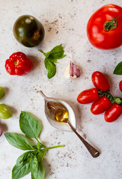 Fresh tomatoes with basil and olive oil.                             