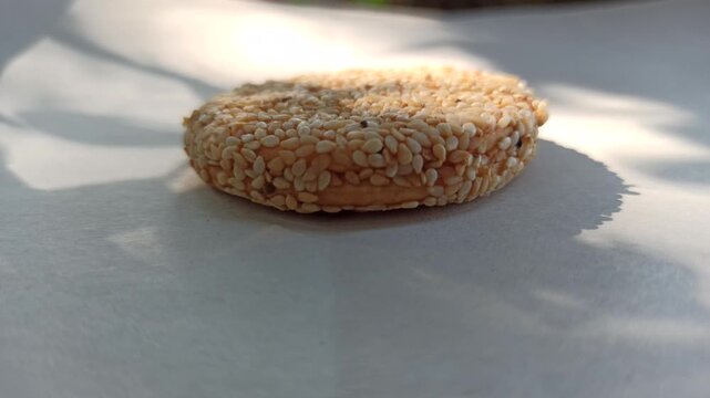 Delicious sesame seed biscuits with a crispy texture and rich nutty flavor, served on a wooden plate. Healthy snack option made with natural ingredients, perfect for a nutritious treat