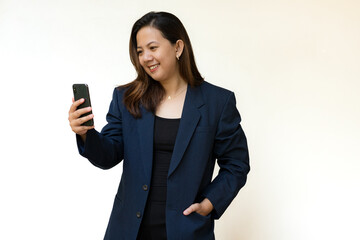 Smiling businesswoman talking on smartphone in studio
