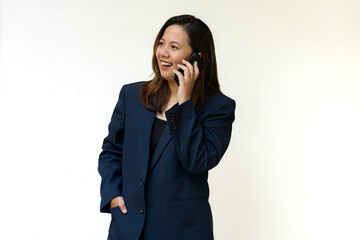 Smiling businesswoman talking on smartphone in studio
