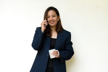 Smiling businesswoman talking on smartphone in studio
