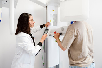 Dentist taking a panoramic dental x-ray of patient