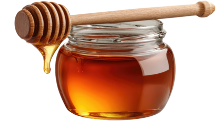 A close-up view of a jar of golden honey with a wooden dipper