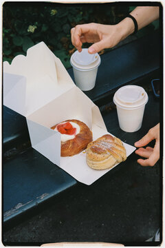 Close-up analog of an anonymous woman opening a box of bread