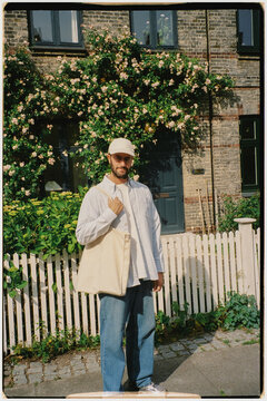 Film portrait of a man posing in front of a Copenhagen residence