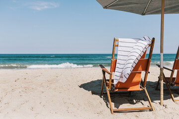 chair, towel, and umbrella on a beach