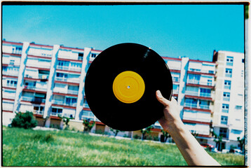 vinyl record in front of apartment block, 35mm
