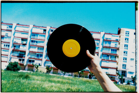 vinyl record in front of apartment block, 35mm