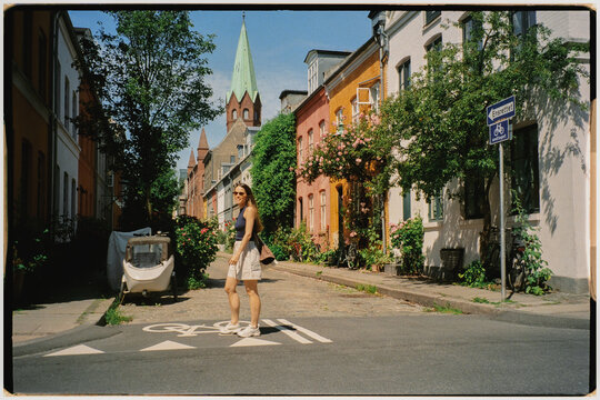 Analog shot of a woman walking calmly along Nyboder, Copenhagen