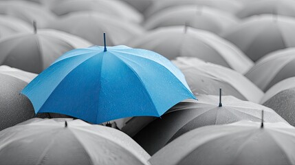 Blue umbrella amidst a sea of gray