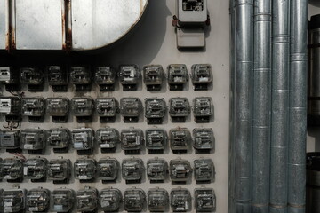 Old electric meters are arranged in a row to create a unique and cool look