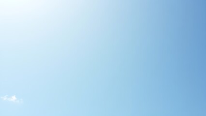 Cloudless blue sky with vintage film grain effect and soft sunlight in minimalist style.