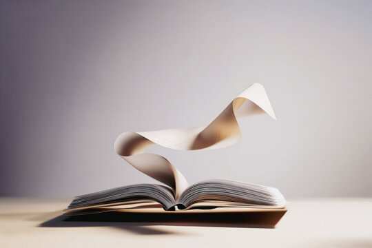 Open book with flowing pages in soft light showcasing 