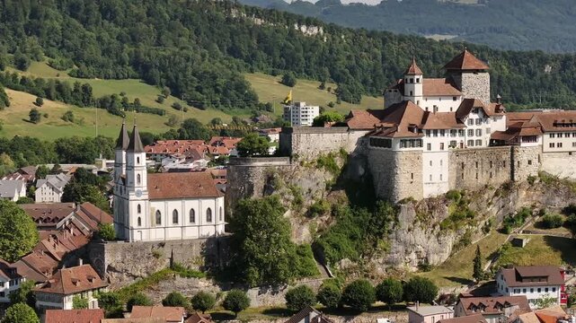 Aerial view of Aarburg&rsquo;s medieval castle and church perched above the Aare River, surrounded by quaint rooftops and lush Swiss countryside in the canton of Solothurn.