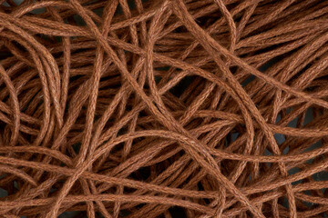 Top view macro of tangled brown jute rope as an abstract background.