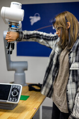 Person interacting with a robotic arm, gripping its mechanical hand in a technology lab, demonstrating human-robot collaboration and modern automation