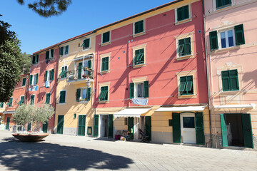 Old street in Italian countryside near sea. Traditional building. Sun day. Entrance, window to house. Nature and sky.