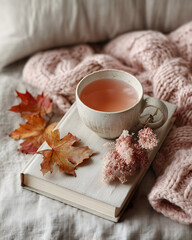 A charmingly simple image of a single cup of tea alongside delicate cookies and a vibrant bouquet of flowers
