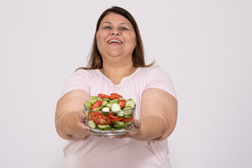 Joyful indian overweight fat woman holding bowl of healthy salad, dieting for weight loss, fitness...