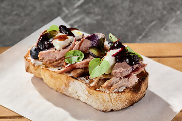 Duck bruschetta with berry jam, bright natural light, angled closeup composition