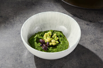 Avocado spinach spread with pita, bright lighting, overhead composition