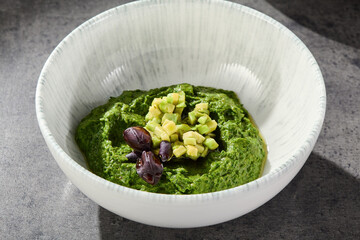 Avocado and spinach spread in bright overhead presentation with minimalist ceramic bowl