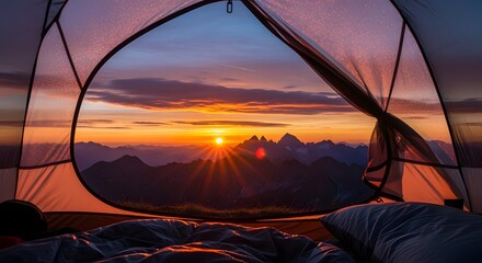 View from inside a tent shows a vibrant sunrise over a mountainous landscape with a clear sky and visible sun rays.