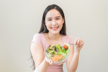 Diet concept, happy smile asian young woman use fork to prick tomato, fresh vegetable or green...