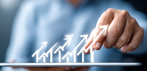 Business person interacting with increasing graphic arrows on tablet