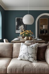 Elegant modern living room interior with a beige sofa, decorative cushions, stylish pendant light, and fresh yellow tulips in a vase, creating a cozy atmosphere with sophisticated design elements