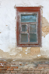 Old wooden window on weathered brick wall