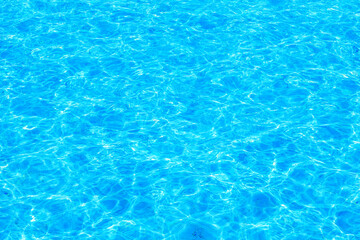 Rippling water surface of a bright blue swimming pool