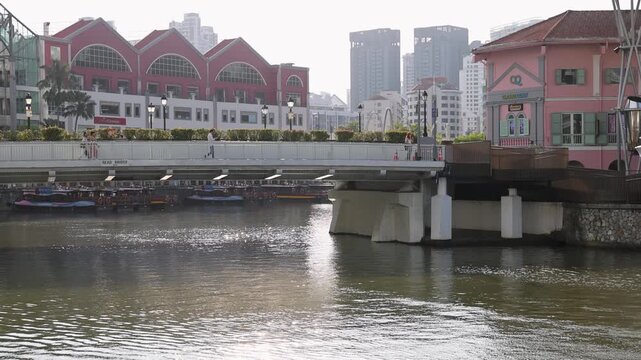 River Cruise Boat Passing Under Clarke Quay Bridge in Singapore
