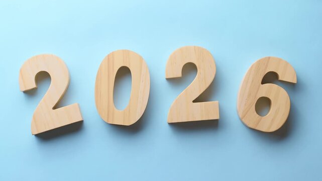 Hand moving years from 2025 to 2026.