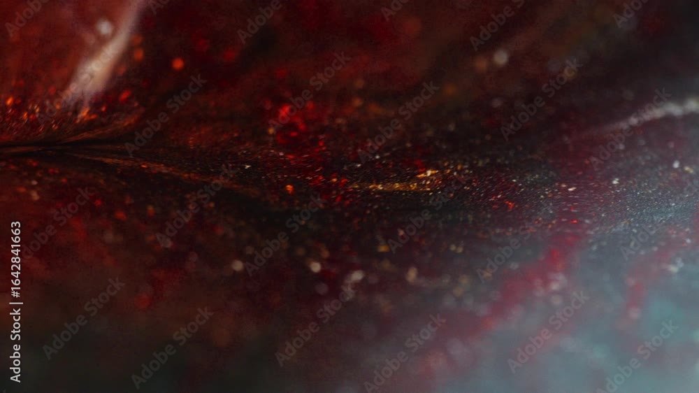 Poster macro shot of burgundy ink with orange reflections being drawn to the left side of the frame, creati