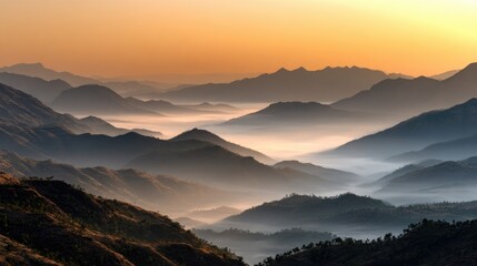 Mountains Silhouette in Mist: A breathtaking panorama capturing the majestic mountain silhouettes emerging from a sea of ethereal mist under the warm embrace of the sun.