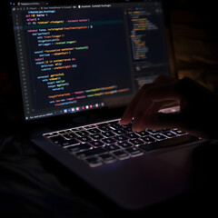 Generative AI in action. A hand types on a glowing laptop keyboard, and the screen displays a code that autonomously generates new content, ideas, or business strategies. Focus on the seamless fusion 