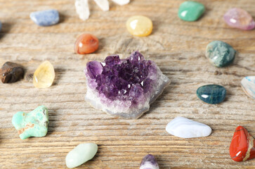 Aura. Different natural mineral stones on wooden table, closeup