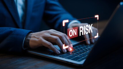 Businessman assessing risk with laptop, emphasizing digital cybersecurity concerns