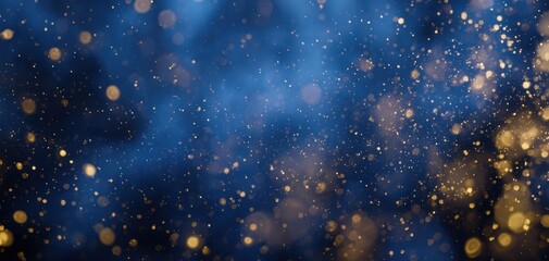 Fototapeta premium The shimmering gold particles dance against a deep blue background.