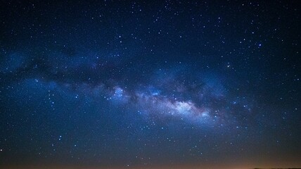 Obraz premium The night sky is filled with stars and the Milky Way