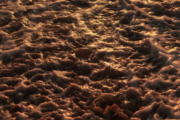 Ocean foam texture in a Vietnamese beach at sunrise, Da Nang