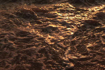 Ocean foam texture in a Vietnamese beach at sunrise, Da Nang