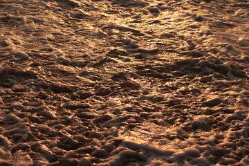 Ocean foam texture in a Vietnamese beach at sunrise, Da Nang